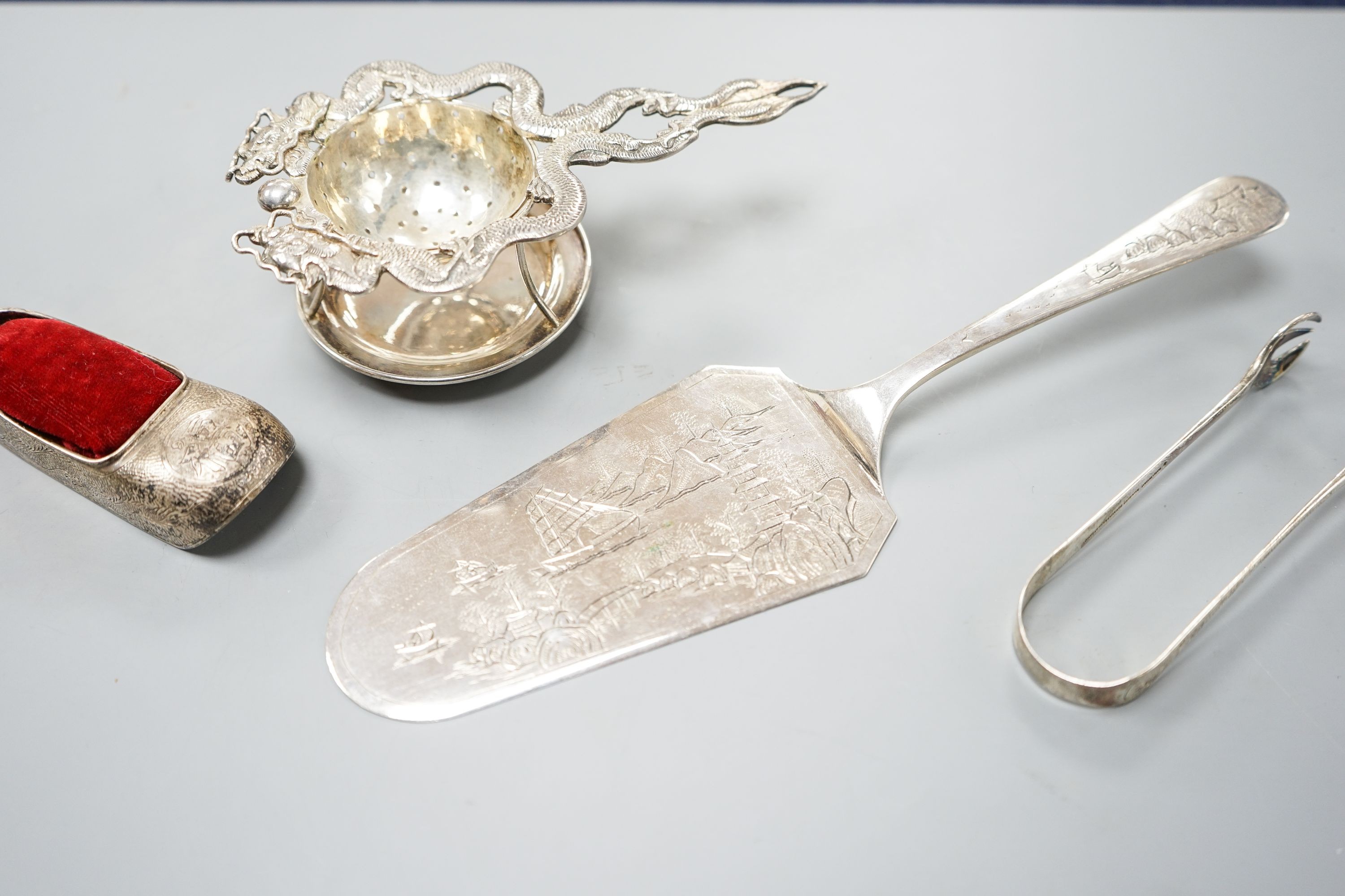 A Chinese white metal cake slice by Tack Hing, 24.4cm and a tea strainer on stand, pair of sugar tongs and pin cushion by Kingsburg, Hong Kong.